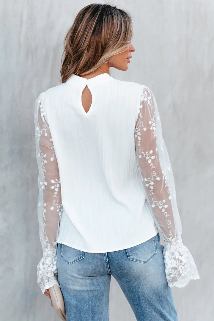 WITTE BLOUSE MET ELEGANTE MOUWEN